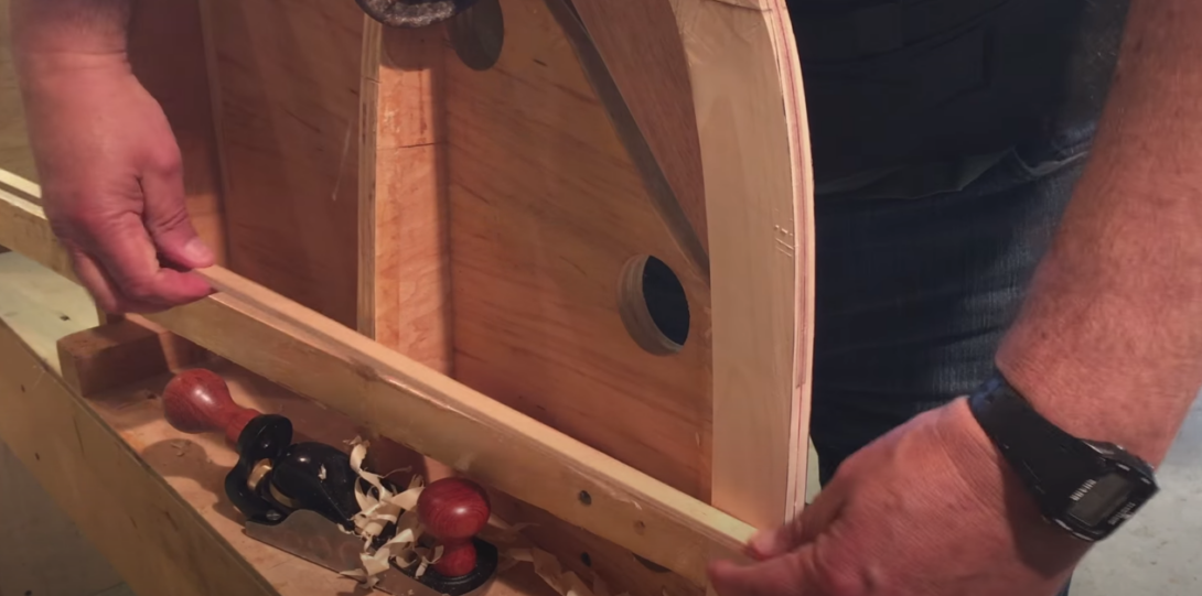 person repairing canoe stem